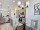 Bright kitchen with island, pendant lighting, and stainless-steel appliances at 3138 Aurea Pl, The Villages, FL 32163