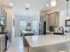 Open kitchen with granite countertops, stainless steel appliances, and center island at 3138 Aurea Pl, The Villages, FL 32163
