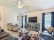 Cozy living room with ceiling fan, modern furniture, and stylish decor at 3138 Aurea Pl, The Villages, FL 32163