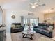 Inviting living room featuring comfortable seating, a ceiling fan, and sliding glass doors at 3138 Aurea Pl, The Villages, FL 32163