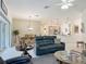 Open-concept living room with modern decor, dining area, and access to the kitchen at 3138 Aurea Pl, The Villages, FL 32163