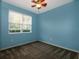 Bedroom featuring blue walls, a ceiling fan and a window with blinds at 3194 Bayou Ln, Tavares, FL 32778