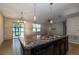 Bright and airy kitchen with an island, stainless steel sink, and view of the screened patio at 3194 Bayou Ln, Tavares, FL 32778