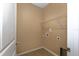 Compact laundry room with tile flooring, white walls, and utility connections at 3194 Bayou Ln, Tavares, FL 32778