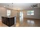 Open concept living space with a kitchen island, ceiling fan, and views of the backyard at 3194 Bayou Ln, Tavares, FL 32778