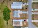 Aerial view showcases the property with a well-defined boundary, driveway, and surrounding neighborhood layout at 32521 W Golf Ct, Leesburg, FL 34748