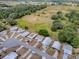 Aerial view of the property within a quiet community, near open fields and mature trees at 32521 W Golf Ct, Leesburg, FL 34748