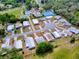 Aerial view highlighting the property's location near community amenities, including a pool and tennis courts at 32521 W Golf Ct, Leesburg, FL 34748