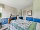 Bedroom featuring a quilt, side table and a framed print on the wall at 32521 W Golf Ct, Leesburg, FL 34748
