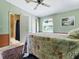 A spacious bedroom with ensuite bathroom featuring ample natural light and pleasant decor at 32521 W Golf Ct, Leesburg, FL 34748
