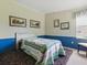 Bedroom featuring colorful quilts, framed wall art and a window with valance at 32521 W Golf Ct, Leesburg, FL 34748
