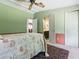 A bedroom with access to an attached bathroom and a hallway featuring neutral tones at 32521 W Golf Ct, Leesburg, FL 34748
