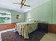 A bright bedroom features a ceiling fan, warm colors, and a cozy feel at 32521 W Golf Ct, Leesburg, FL 34748