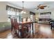 Dining area featuring laminate floors and a view into the spacious living room at 32521 W Golf Ct, Leesburg, FL 34748