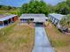 Charming single-story home featuring a screened-in porch, covered carport, and well-maintained front lawn at 32521 W Golf Ct, Leesburg, FL 34748