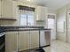 A functional kitchen with stainless steel appliances, granite counters, and ample cabinets at 32521 W Golf Ct, Leesburg, FL 34748