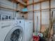 Laundry area with a modern washer and dryer set and shelving at 32521 W Golf Ct, Leesburg, FL 34748
