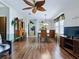 Spacious living room featuring laminate floors, a ceiling fan, and an open dining area at 32521 W Golf Ct, Leesburg, FL 34748