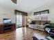 Cozy living room with laminate floors, a comfortable sofa, and a sliding glass door at 32521 W Golf Ct, Leesburg, FL 34748