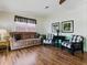 Comfortable living room with laminate floors, a plush sofa, and decorative wall art at 32521 W Golf Ct, Leesburg, FL 34748