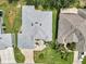A stunning aerial view of a well-maintained home with a manicured lawn and paver driveway at 3677 Arlington Ridge Blvd, Leesburg, FL 34748