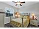 Cozy bedroom features a wooden bed frame, ceiling fan, and charming décor at 3677 Arlington Ridge Blvd, Leesburg, FL 34748