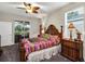 Comfortable bedroom with tropical ceiling fan and access to screened lanai at 3677 Arlington Ridge Blvd, Leesburg, FL 34748