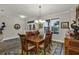 Bright dining room with wooden table set, decorative rug, and natural light from the window at 3677 Arlington Ridge Blvd, Leesburg, FL 34748