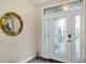 Elegant entryway featuring a decorative glass front door and a stylish mirror that add character to the space at 3677 Arlington Ridge Blvd, Leesburg, FL 34748