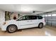 Spacious two car garage with a white minivan and epoxy floor at 3677 Arlington Ridge Blvd, Leesburg, FL 34748