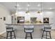 Spacious kitchen island with barstool seating and stainless steel appliances at 3677 Arlington Ridge Blvd, Leesburg, FL 34748