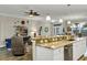 Bright open floorplan with a modern kitchen overlooking the living room and dining area at 3677 Arlington Ridge Blvd, Leesburg, FL 34748