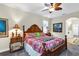 Comfortable main bedroom with wood furniture and decorative floral bedding at 3677 Arlington Ridge Blvd, Leesburg, FL 34748