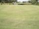 Putting green with manicured grass, marked holes, and surrounding golf carts in the background at 3677 Arlington Ridge Blvd, Leesburg, FL 34748