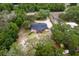 Aerial view of a single-Gathering home with a screened porch, surrounded by trees and a circular driveway at 39812 French Rd, Lady Lake, FL 32159