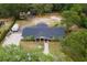 Expansive aerial view of the property showcasing lush greenery, mature trees, and large building at 39812 French Rd, Lady Lake, FL 32159