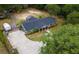 Aerial view of the property showcasing the well-maintained lawn, mature trees, and expansive driveway at 39812 French Rd, Lady Lake, FL 32159