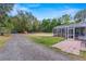 Expansive backyard showcasing the property's outdoor space, screened-in patio, and ample greenery at 39812 French Rd, Lady Lake, FL 32159