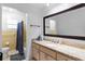 Bathroom featuring a granite vanity, large mirror, and a separate shower/tub area at 39812 French Rd, Lady Lake, FL 32159
