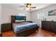 Comfortable bedroom featuring hardwood floors, neutral walls, a ceiling fan, and ample natural light at 39812 French Rd, Lady Lake, FL 32159