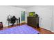 Bedroom with hardwood floors, dresser, and workstation offering a comfortable and functional living space at 39812 French Rd, Lady Lake, FL 32159