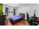 Cozy bedroom with hardwood floors, a window with gray curtains, and a work desk at 39812 French Rd, Lady Lake, FL 32159