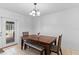 Dining area featuring stylish table with wooden chairs and bench seating and backyard views at 39812 French Rd, Lady Lake, FL 32159