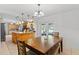 Comfortable dining area adjacent to the kitchen featuring stylish table with bench seating and backyard access at 39812 French Rd, Lady Lake, FL 32159