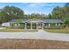 Charming single-story home with a manicured front yard, complemented by fresh exterior paint and mature landscaping at 39812 French Rd, Lady Lake, FL 32159