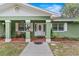 Inviting front porch features a cozy seating area, stylish decor, and well-maintained landscaping at 39812 French Rd, Lady Lake, FL 32159