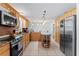 Spacious kitchen featuring tile floors, stainless appliances, wooden cabinets and large central island at 39812 French Rd, Lady Lake, FL 32159