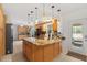 Bright eat-in kitchen featuring a center island with granite counters, pendant lighting, and wood cabinetry at 39812 French Rd, Lady Lake, FL 32159