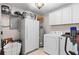 Efficient laundry room with appliances, storage cabinets, and shelving for organized convenience at 39812 French Rd, Lady Lake, FL 32159