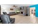 Spacious living room features tile flooring, a brick fireplace, and ample seating for relaxation and entertainment at 39812 French Rd, Lady Lake, FL 32159
